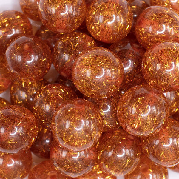 close up view of a pile of 20mm Orange Glitter Tinsel Bubblegum Beads