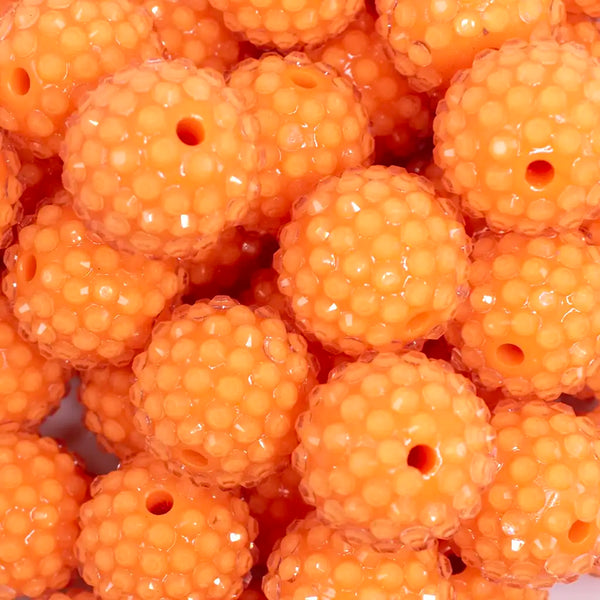 close up view of a pile of 20mm Orange with Clear Rhinestone Bubblegum Beads