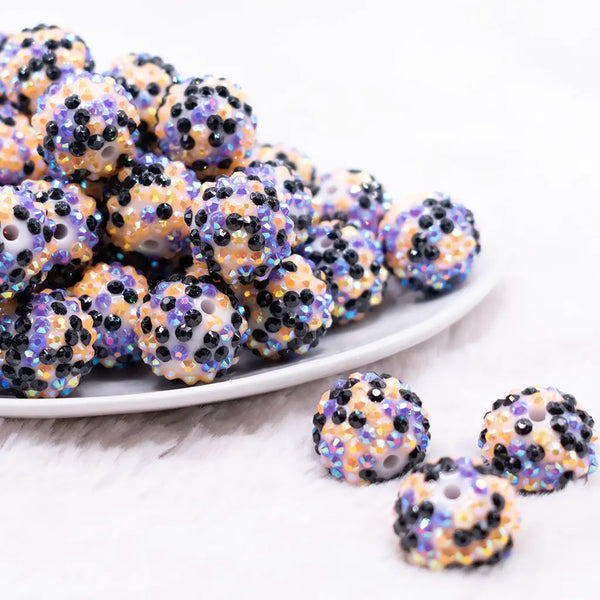 front view of a pile of 20mm Purple, Orange and Black Confetti Rhinestone Bubblegum Beads