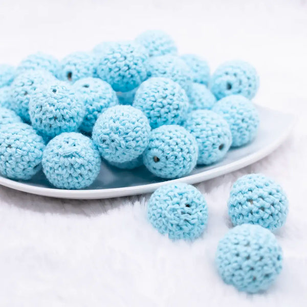front view of a pile of 20mm Pastel Blue Crochet wooden bead