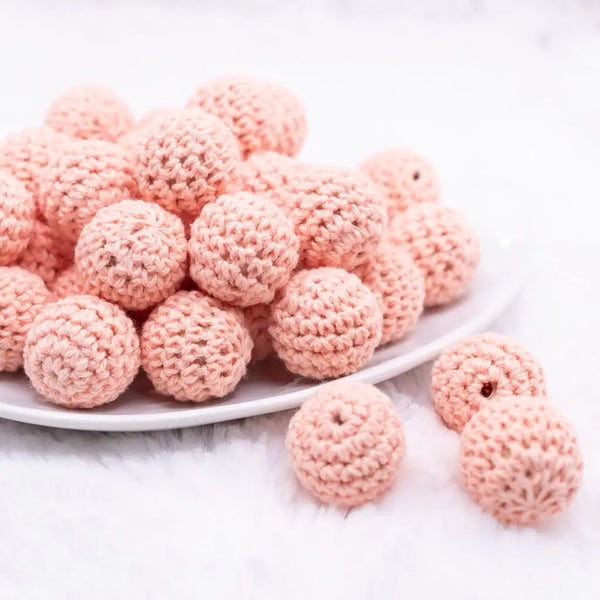 front view of a pile of 20mm peach Crochet wooden bead