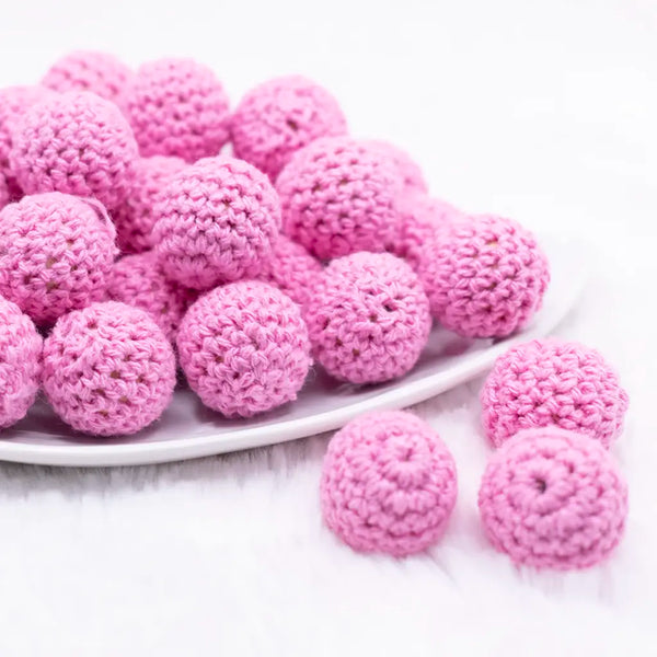 front view of a pile of 20mm Pink Crochet wooden bead