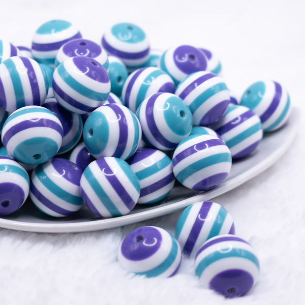 front view of a pile of 20mm Teal and Purple Stripes Bubblegum Jewelry Beads
