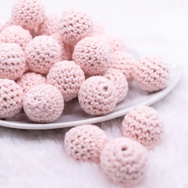 front view of a pile of 20mm Quartz Pink Crochet wooden bead