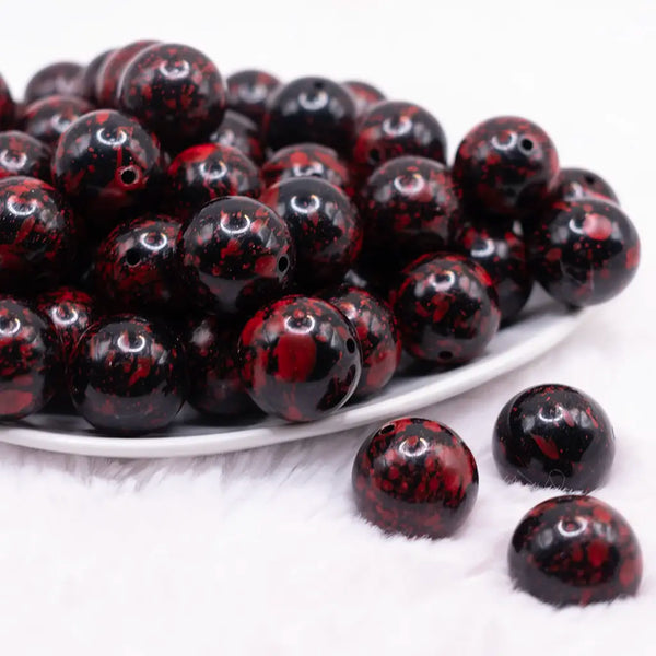 front view of a pile of 20mm Red and Black Splatter Bubblegum Beads
