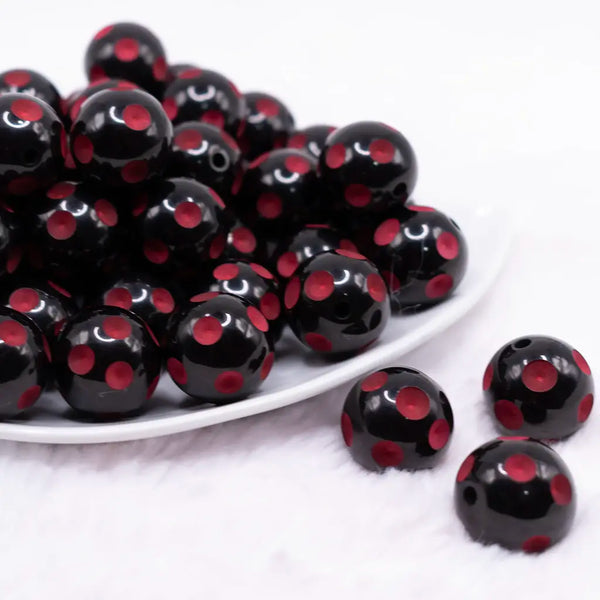 front view of a pile of 20mm Red Polka Dots on Black Acrylic Bubblegum Beads
