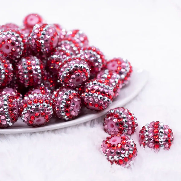 front view of a pile of 20mm Pink, Red & Silver Striped Rhinestone AB Bubblegum Beads