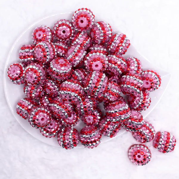 top view of a pile of 20mm Pink, Red & Silver Striped Rhinestone AB Bubblegum Beads