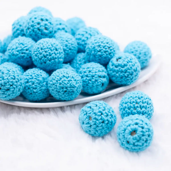front view of a pile of 20mm sky blue Crochet wooden bead