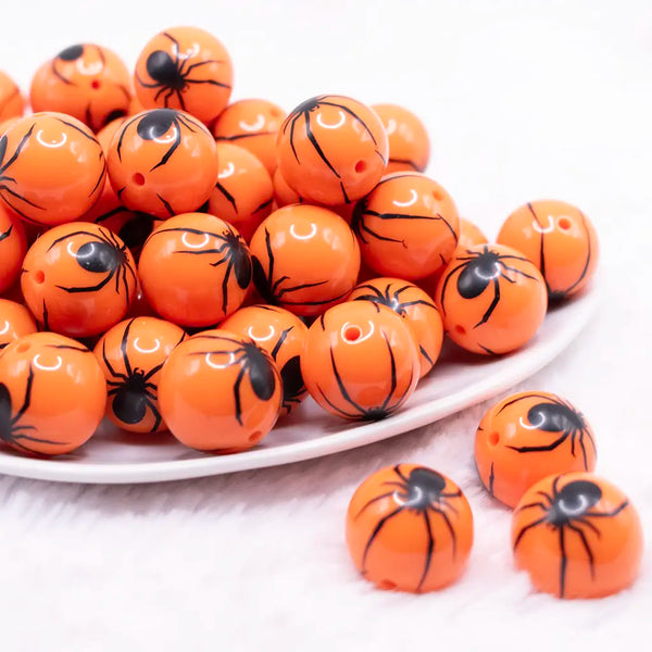 front view of a pile of 20mm Spider Print on Orange Bubblegum Beads