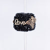 inspiration view of a pile of 20mm Black Square luxury bead with gold Bee and Love Accents