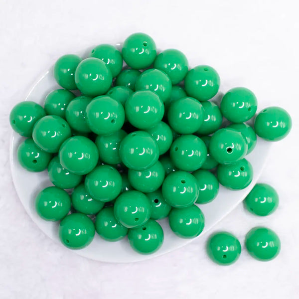 top view of pile of 20mm kelly green solid bubblegum bead 