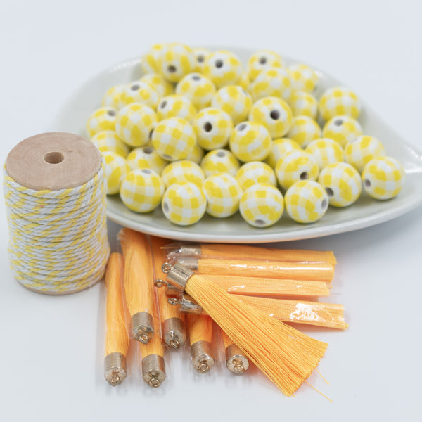 front view of a pile of DIY 16mm Yellow and White Plaid Wood Garland Starter Kit - Over 50 pieces