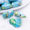 close up view of a pile of 23mm Blue Watercolor Heart Acrylic Bead