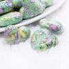 close up view of a pile of 23mm Green Watercolor Heart Acrylic Bead