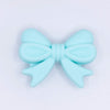 top view of a pile of 25mm Aqua Bow Knot silicone bead