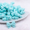 front view of a pile of 25mm Aqua Bow Knot silicone bead