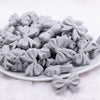 front view of a pile of 25mm Light Gray Bow Knot silicone bead