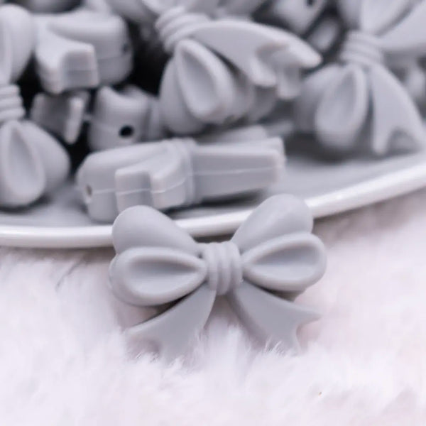 close up view of a pile of 25mm Light Gray Bow Knot silicone bead