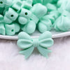 close up view of a pile of 25mm Mint Green Bow Knot silicone bead