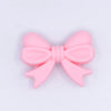 top view of a pile of 25mm Quartz Pink Bow Knot silicone bead