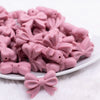 front view of a pile of 25mm Rose Pink Bow Knot silicone bead