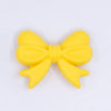 top view of a pile of 25mm Yellow Bow Knot silicone bead