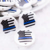 close up view of a pile of 25mm Police Shield Print Flat Disc Acrylic Bubblegum Beads - 10 Count
