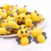 front view of a pile of 3D Bee silicone focal bead