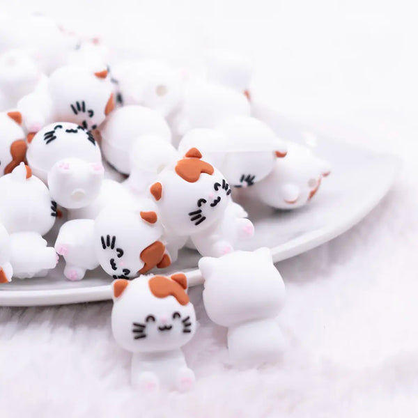 front view of a pile of 3D Cat silicone focal bead