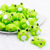 front  view of a pile of 3D Green Frog silicone focal bead