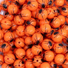 close up of a pile of 12mm Orange with Black Spider Print Bubblegum Beads