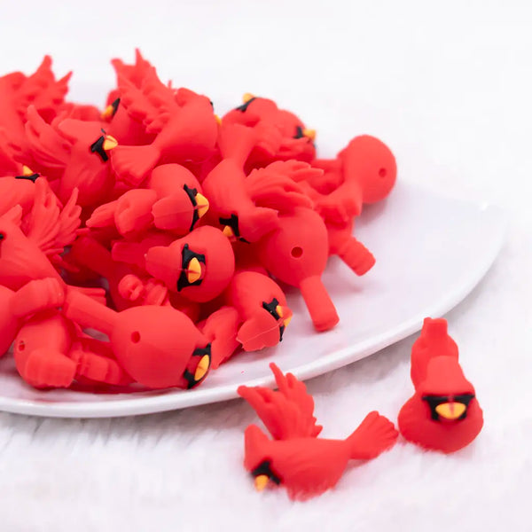 front view of a pile of 3D Red Cardinal Silicone Focal Bead Accessory
