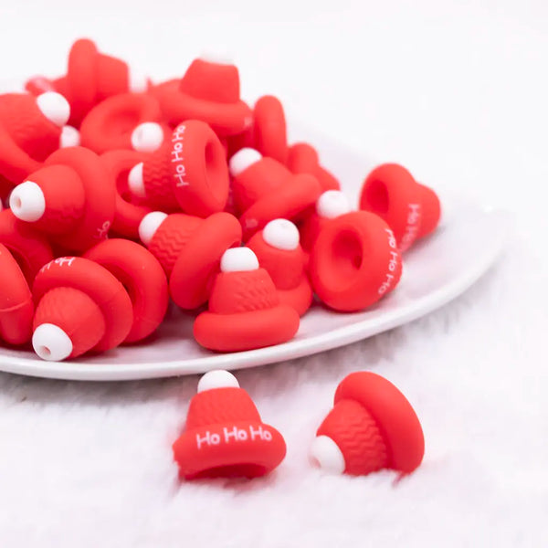 front view of a pile of 3D Red Santa Hat silicone focal bead