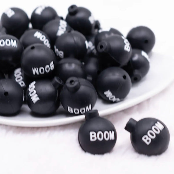 front view of a pile of 3D Black Boom silicone focal bead