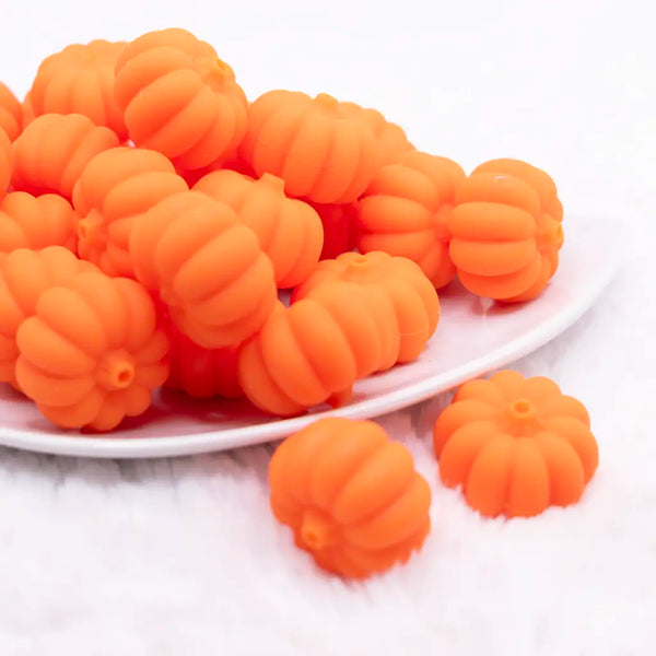 front view of a pile of 3D Pumpkin silicone focal bead