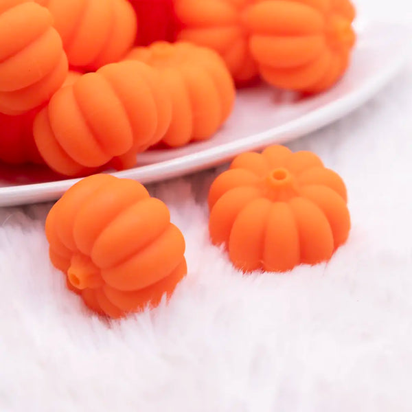 close up view of a pile of 3D Pumpkin silicone focal bead