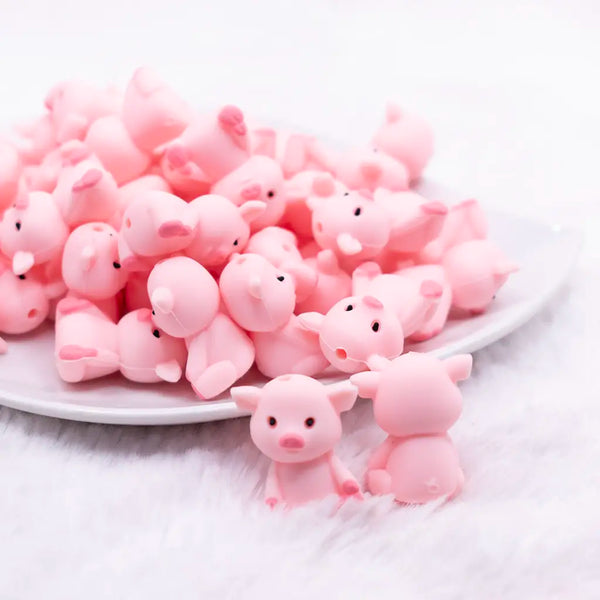 front view of a pile of 3D Pig silicone focal bead