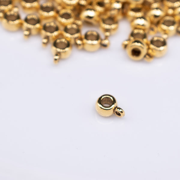 top view of a pile of Gold Spacer with Charm Mount - Set of 10