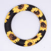 top view of a pile of 65mm sunflower print Design Round Ring Silicone Focal Beads Accessory