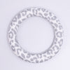 top view of a pile of 65mm gray cow print Design Round Ring Silicone Focal Beads Accessory