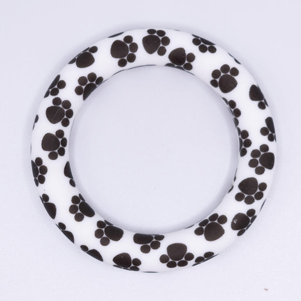 top view of a pile of 65mm paw print Design Round Ring Silicone Focal Beads Accessory