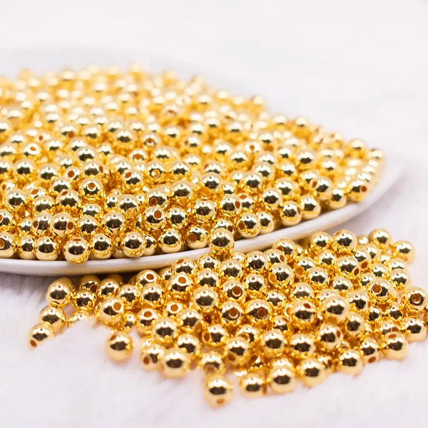 front view of a pile of 6mm Gold Acrylic Spacer Beads