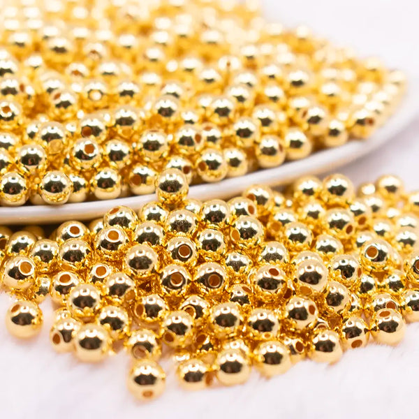 close up view of a pile of 6mm Gold Acrylic Spacer Beads