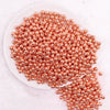 top view of a pile of 6mm Rose Gold Acrylic Spacer Beads