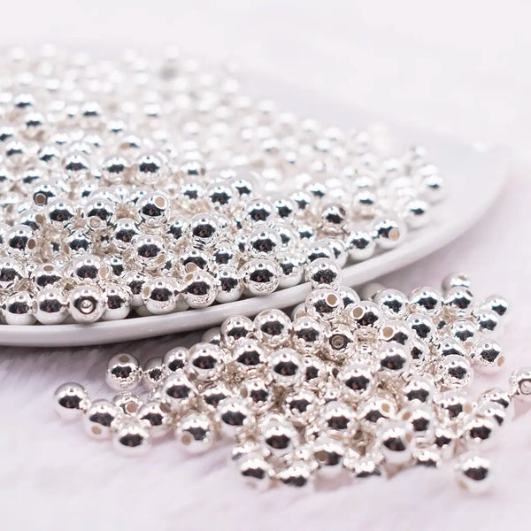 front view of a pile of 6mm Silver Acrylic Spacer Beads