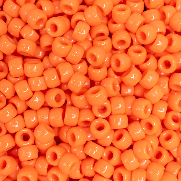 top view of a pile of orange 6mm x 9mm Acrylic Pony Beads