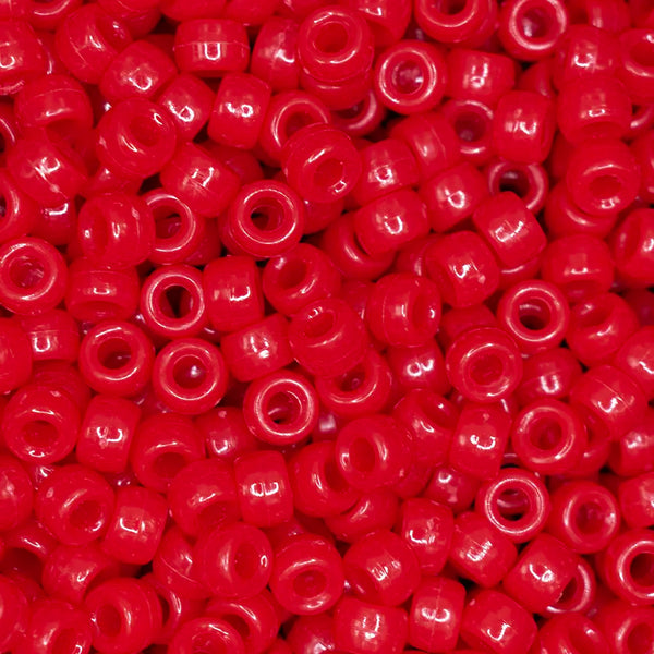 top view of a pile of red 6mm x 9mm Acrylic Pony Beads