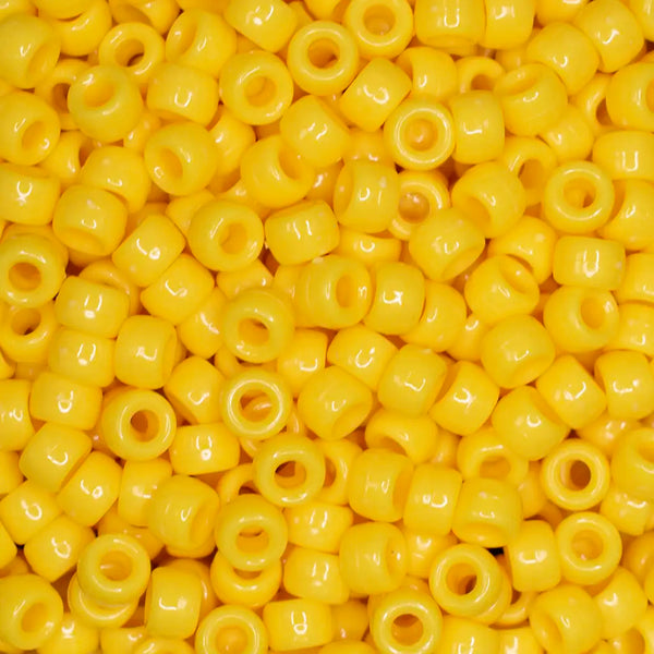 top view of a pile of yellow 6mm x 9mm Acrylic Pony Beads