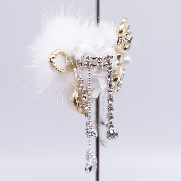 side view of a pile of 48mm Gold Bear double sided acrylic bead with rhinestone and fur surround